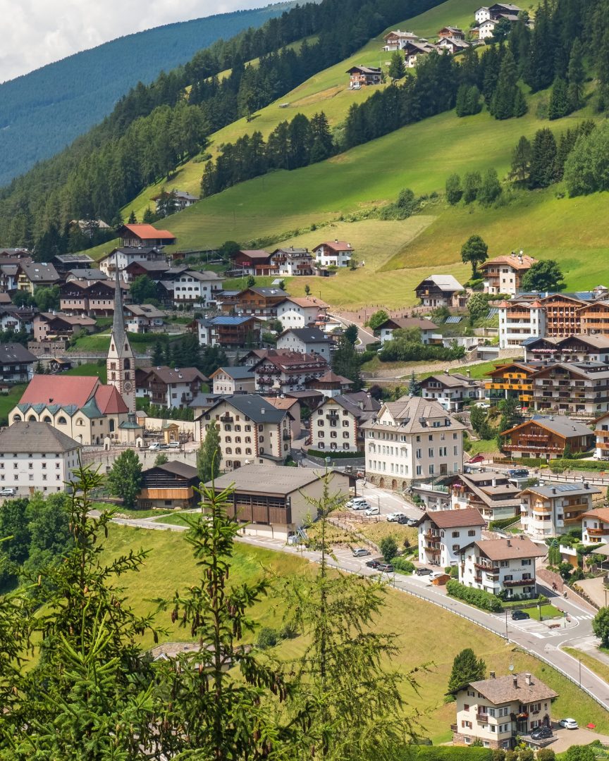 Santa Cristina Val Gardena — view of the village with its church tower among green meadows at 1,428 m